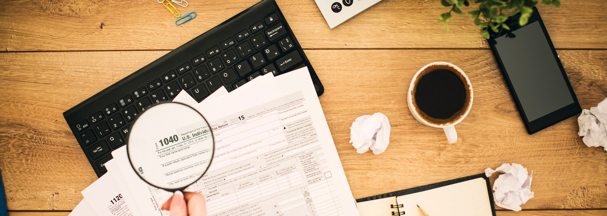 Papers and tax forms on table, directly above shot